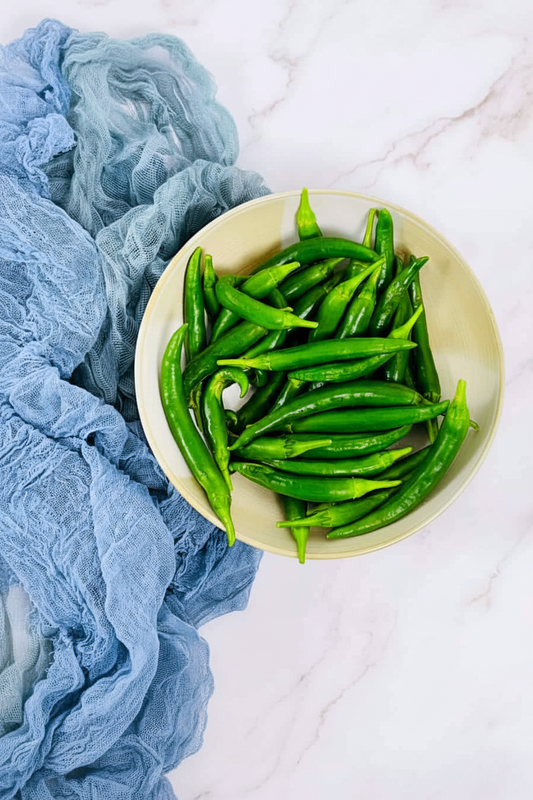 Green chilies portrait flat lay